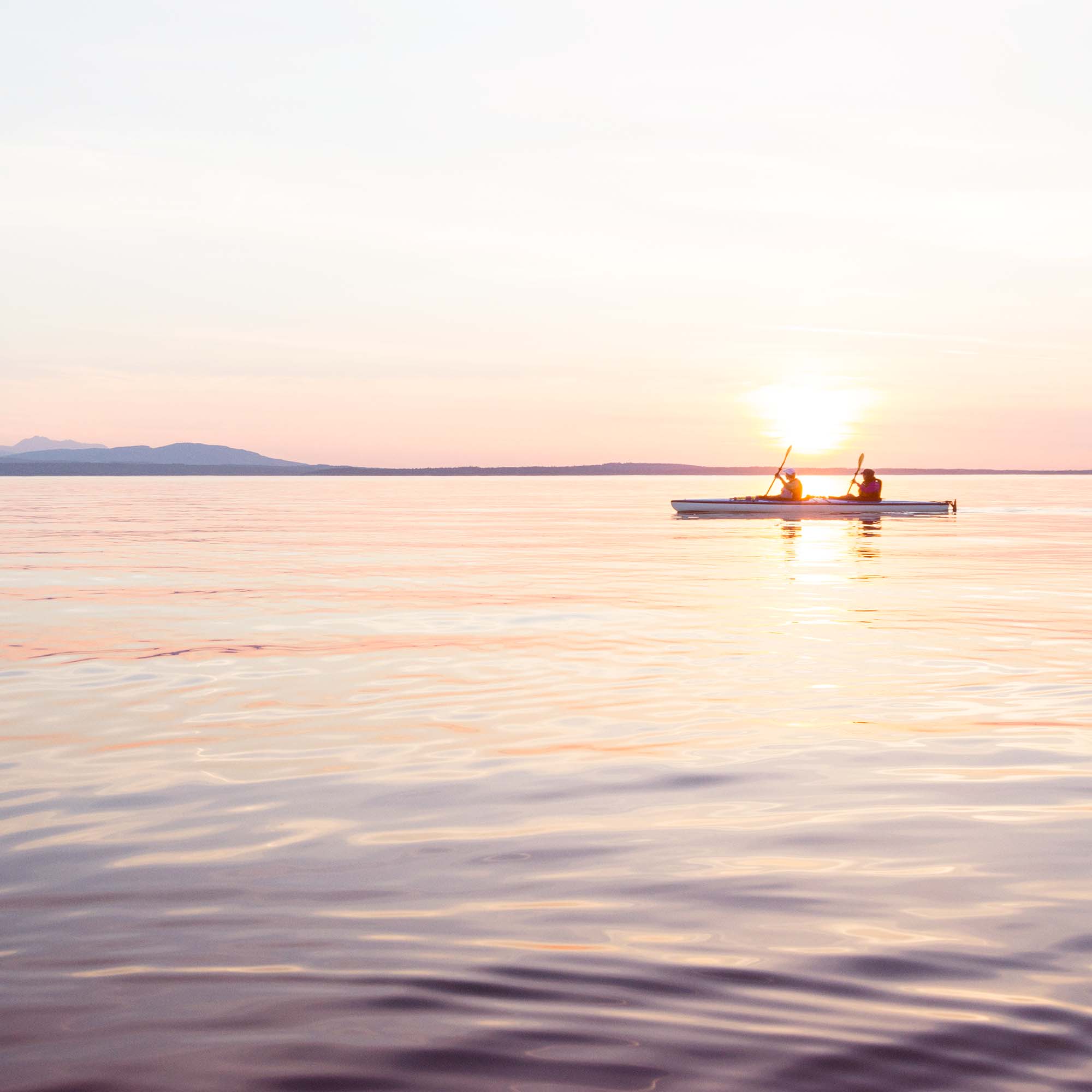 A couple kayaking in the Salish Sea near Bellingham, WA